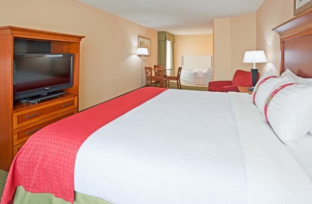 Holiday Inn Elk River suite - bed, tv and whirlpool spa.