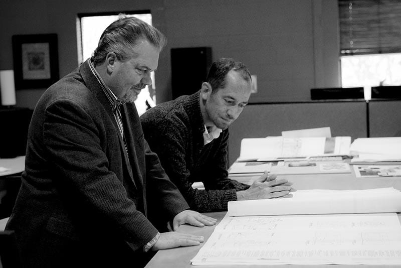 Doug and Doug looking at blueprints.